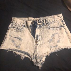 A pair of acid wash distressed forever 21 jeans